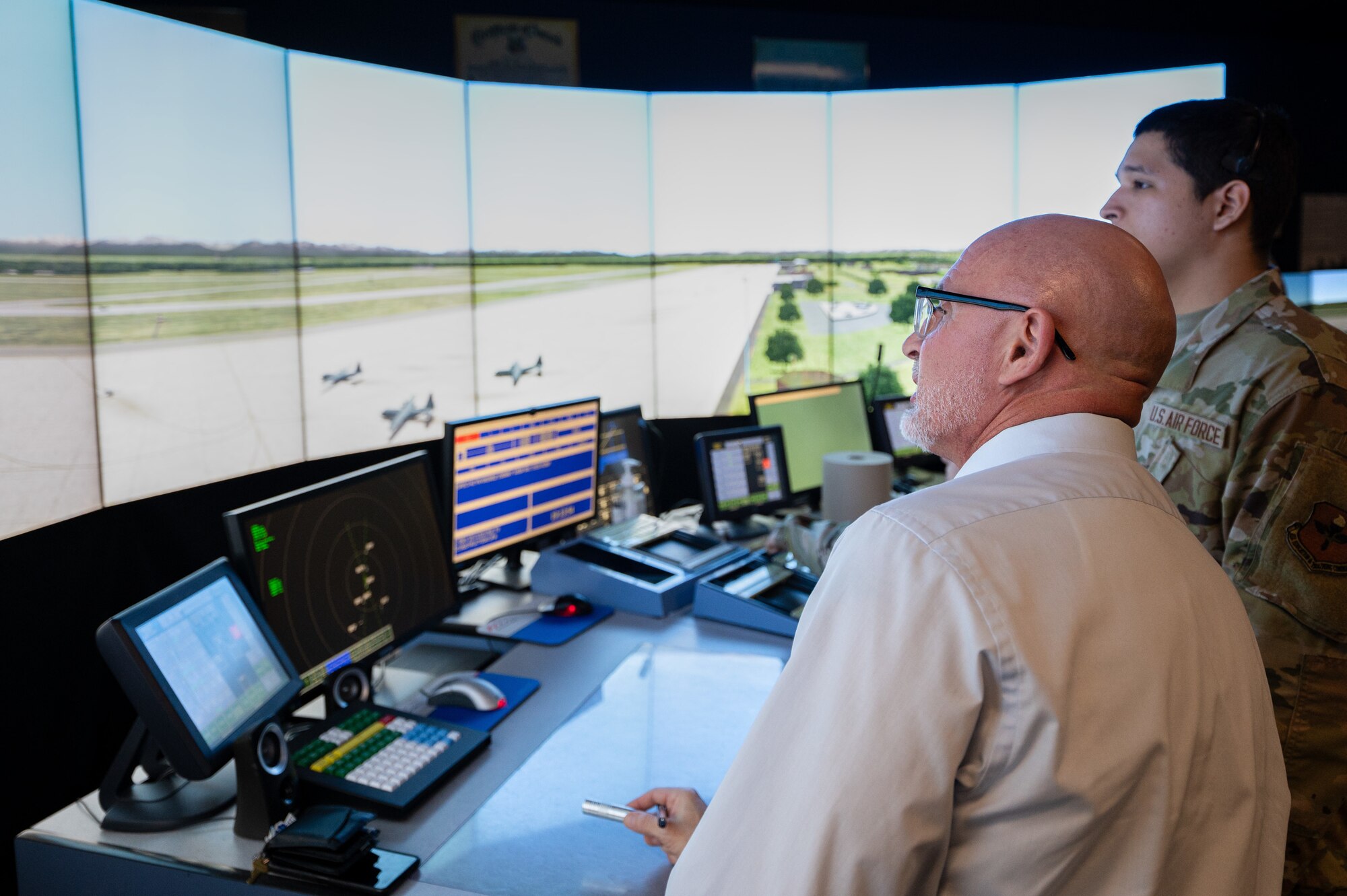 A U.S. Air Force instructor from the 334th Training Squadron teaches a student on the MaxSim Tower Simulator during a tour for the German Military Aviation Authority on Keesler Air Force Base, Mississippi, Feb. 12, 2024.