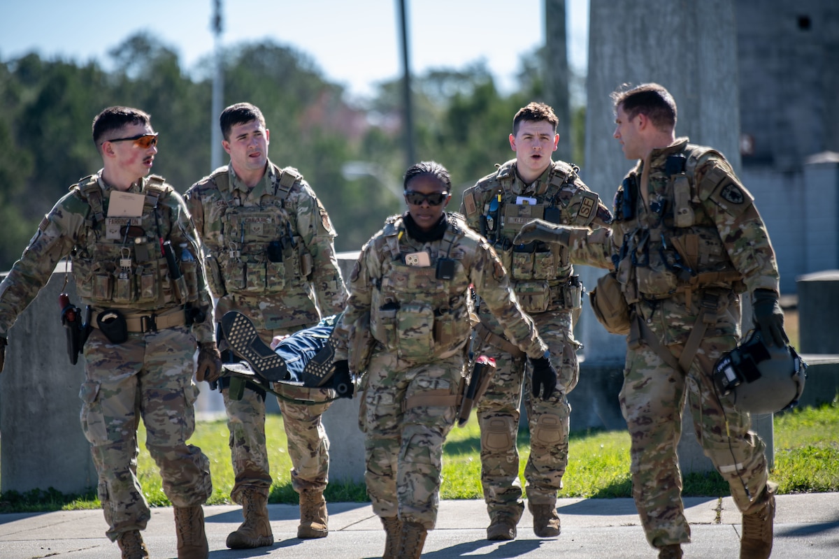 Air National Guard Security Forces Airmen transport a role-play injured victim during a PATRIOT 24 search and rescue exercise, Camp Shelby, Mississippi,  Feb. 19, 2024.