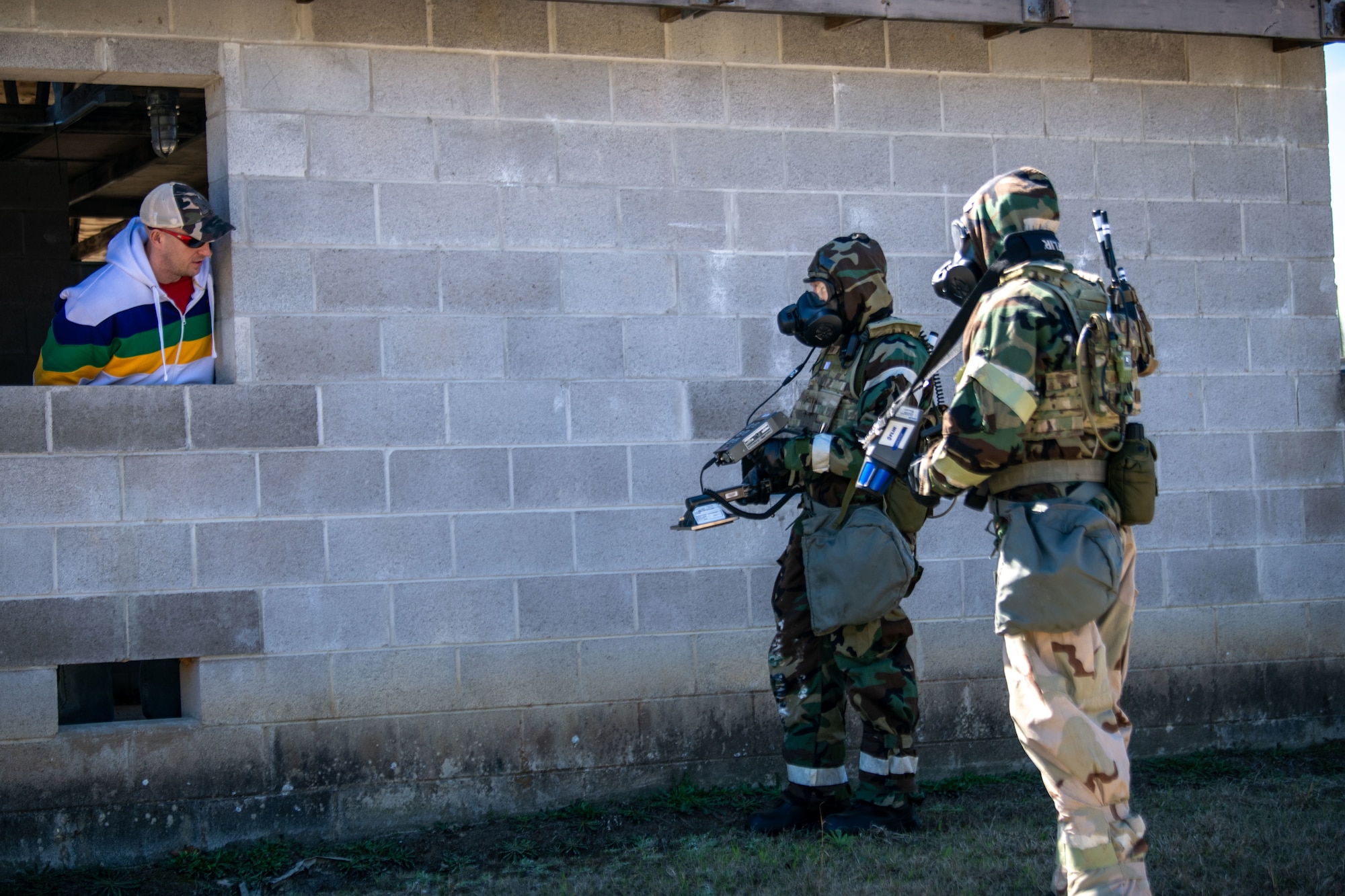Airmen participating in PATRIOT 24 survey an area for radiological hazards and notify a role-play homeowner on proper precautions to take during PATRIOT 24, Camp Shelby, Mississippi, Feb. 19, 2024.