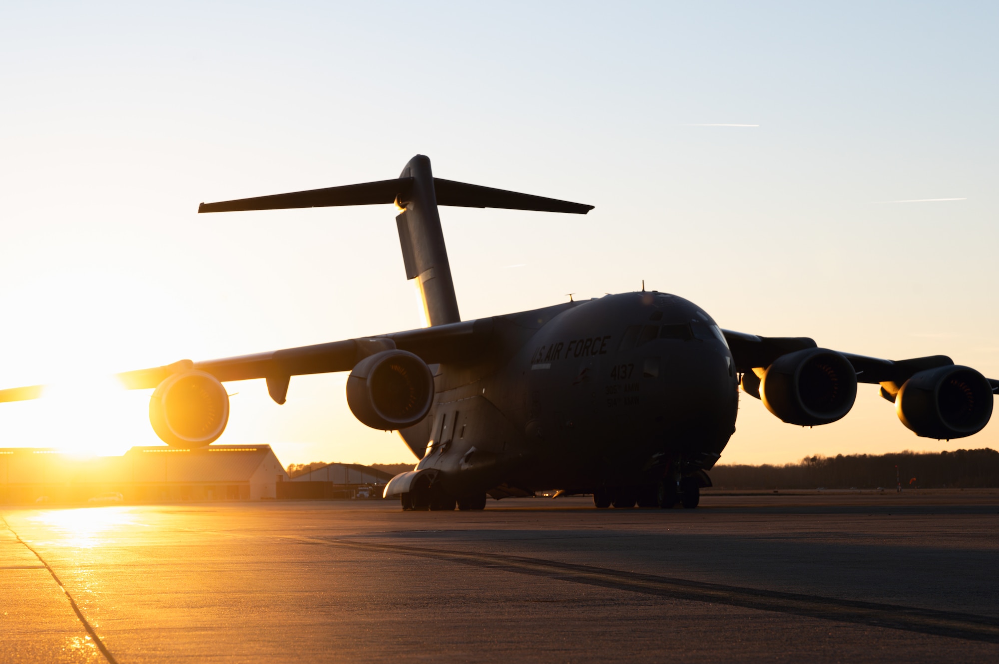 A C-17 Globemaster III sits on the flightline during the Tactics Advancement Course at Joint Base Langley-Eustis, Va., Feb. 7, 2024. Airmen assigned to the 6th Airlift Squadron loaded cargo onto the C-17 in order to provide support for the F-22 Raptors at JBLE. The advancements course postures Air Mobility Command Airmen to execute agile operations on a global scale. (U.S. Air Force photo by Airman 1st Class Aidan Thompson)