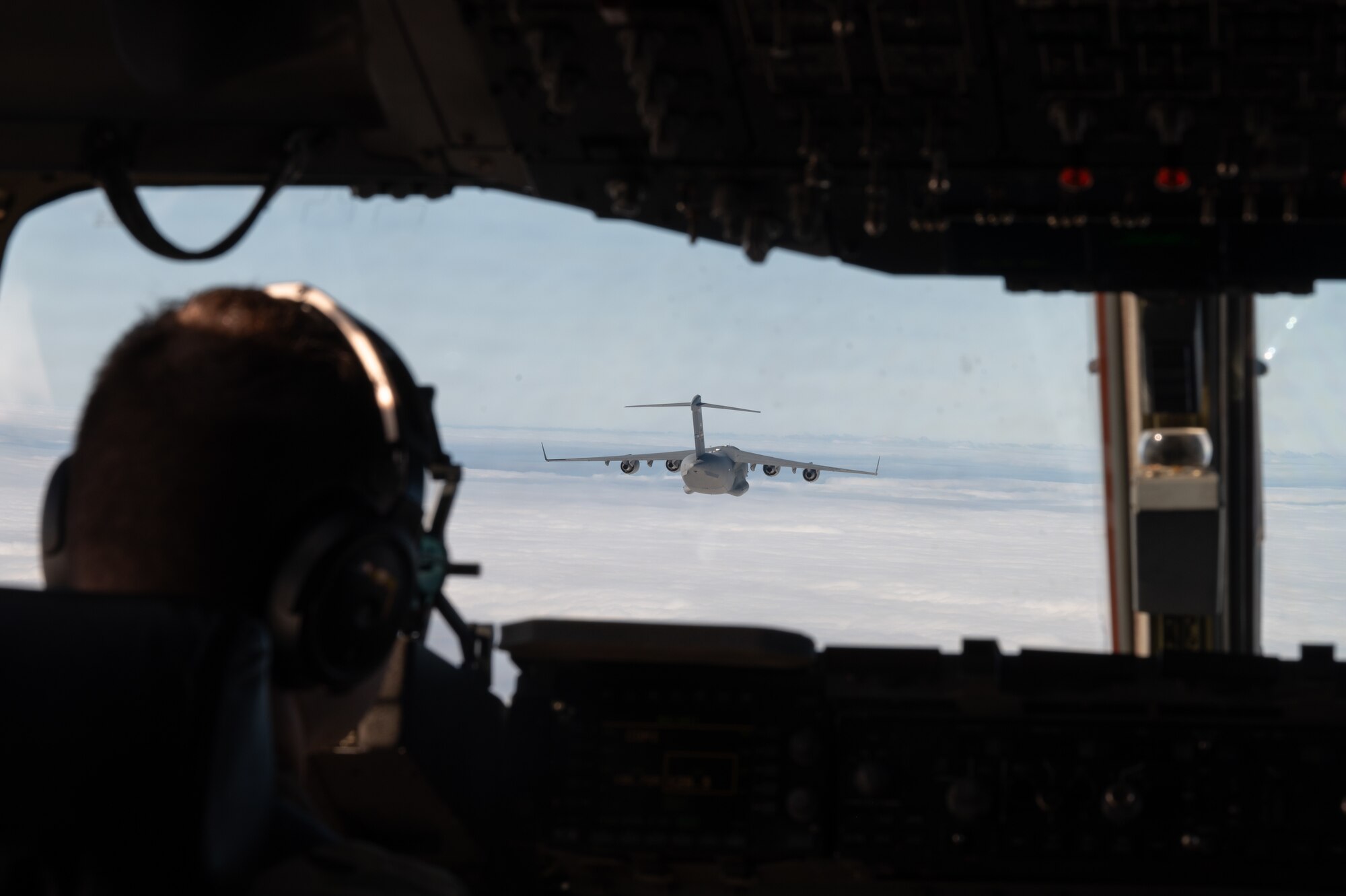 Two C-17 Globemaster IIIs’ trade leading and following positions within their flight path during the Tactics Advancement Course at Joint Base McGuire-Dix-Lakehurst, N.J., Feb. 7, 2024. Airmen assigned to the 6th Airlift Squadron loaded cargo onto the C-17 in order to provide support for the F-22 Raptors at Joint Base Langley-Eustis, Va. The advancements course postures Air Mobility Command Airmen to execute agile operations on a global scale. (U.S. Air Force photo by Airman 1st Class Aidan Thompson)