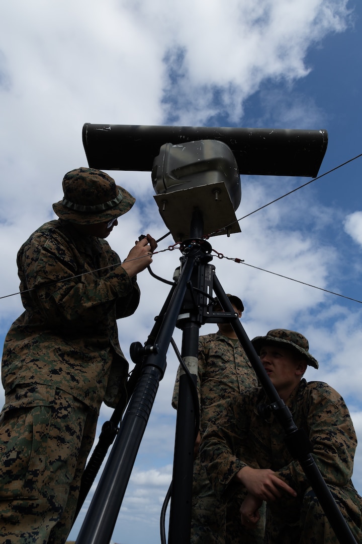 U.S. Marines with 5th Air Naval Gunfire Liaison Company, and 3rd Intelligence Battalion, Maritime Surveillance Platoon, both with III Marine Expeditionary Force Information Group move a commercial radar during a communications field exercise, Rapid Tanto at Ie Shima, Okinawa, Japan, Feb. 6, 2024. The radar allows surveillance of distant maritime activity. Using off-the-shelf radars and low-signature equipment, 5th ANGLICO and 3rd Intel Bn demonstrated proficiency in planning, coordination, and execution of dynamic targeting capable of supporting maritime campaigns in an increasingly contested Indo-Pacific. (U.S. Marine Corps photo by Cpl. William Wallace)