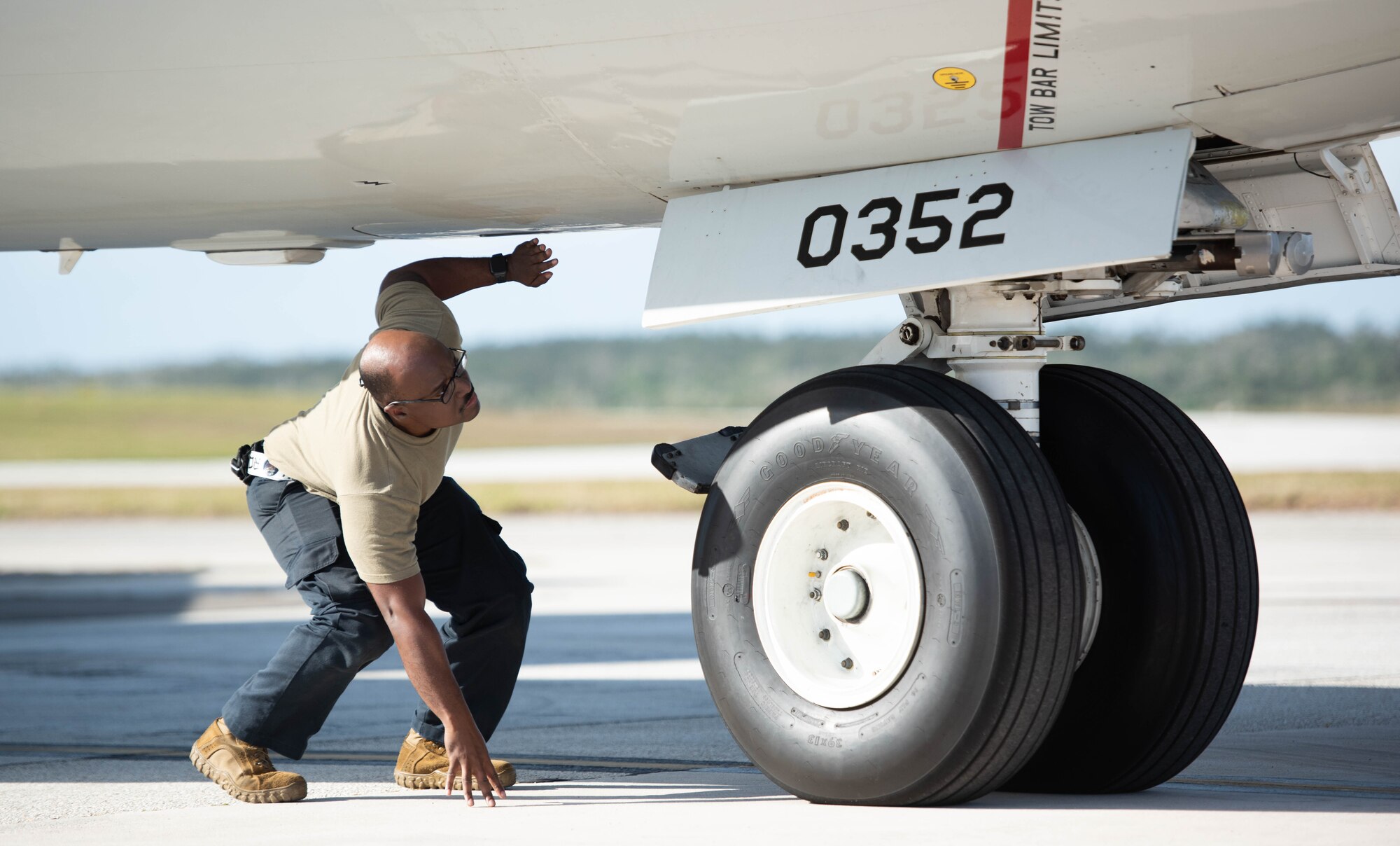 An Airman conducts pre-flight procedures.