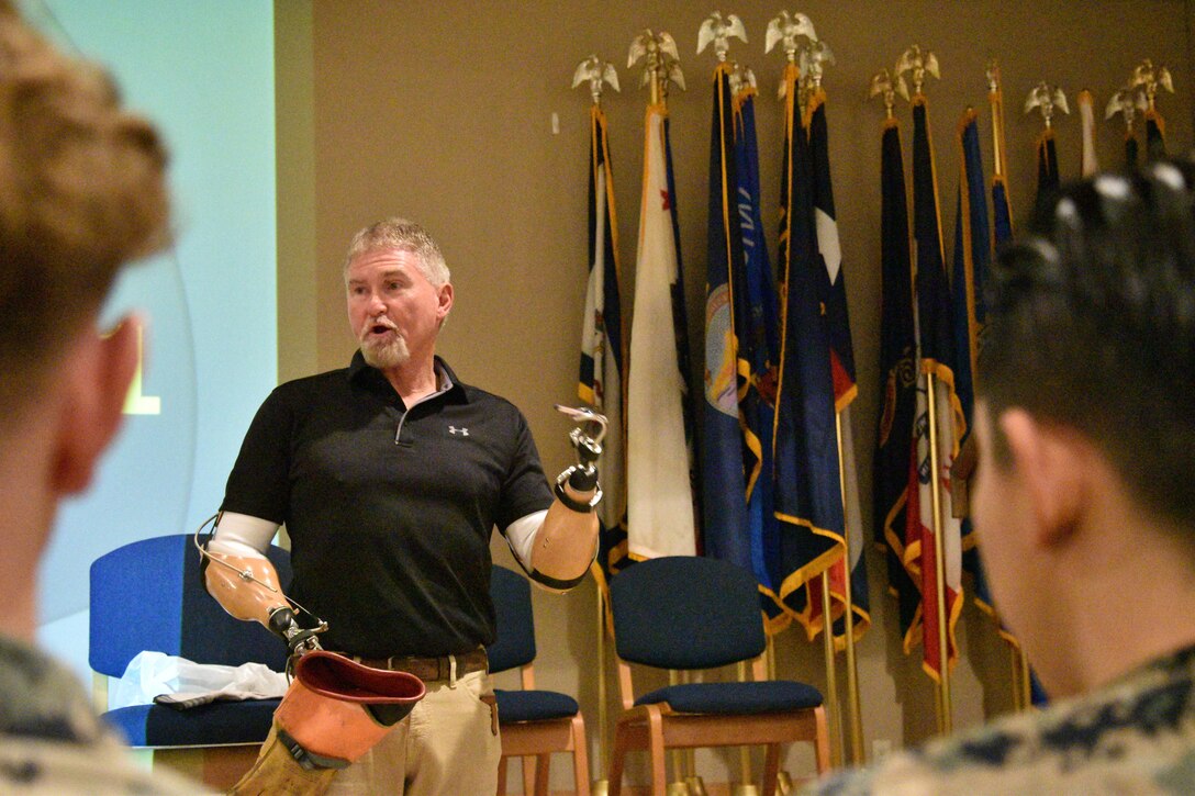 Lee Shelby explains how different types of gloves offer protection while working with electrical equipment to Marines at Combined Arms Training Center, Camp Fuji, Japan, February 15, 2024. (U.S. Marine Corps photo by Song Jordan)