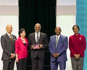 BALTIMORE (Feb. 16, 2024) Dr. Kevin Porter, (center) director of Naval Medical Research Command’s (NMRC) Defense Infectious Diseases Directorate receives the Stars and Stripes United States Federal Agency Leadership Award at the 38th Black Engineer of the Year Awards (BEYA) presentation held at the Baltimore Convention Center. The BEYA Conference is an annual collaborative effort to support and advance diversity within the STEM fields. This award, along with other Stars and Stripes awards, recognize individuals whose leadership and contributions have significantly advanced the mission of the U.S. Military. NMRC is engaged in a broad spectrum of activity from basic science in the laboratory to field studies in austere and remote areas of the world to investigations in operational environments. In support of the Navy, Marine Corps and joint U.S. warfighters, researchers study infectious diseases, biological warfare detection and defense, combat casualty care, environmental health concerns, aerospace and undersea medicine, medical modeling, simulation, operational mission support, epidemiology and behavioral sciences. (U.S. Navy photo by Michael Wilson/Released)