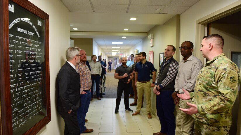 Lt. Col. Robert W. Green (Right), U.S. Army Corps of Engineers Nashville District commander, and Ben Rohrbach (Far Left), Nashville District Engineering and Construction Division chief, recognize the newest licensed professionals affixed onto the “Registered Professional Personnel” board Feb. 20, 2024, at the district headquarters in Nashville, Tennessee. (USACE Photo by Lee Roberts)