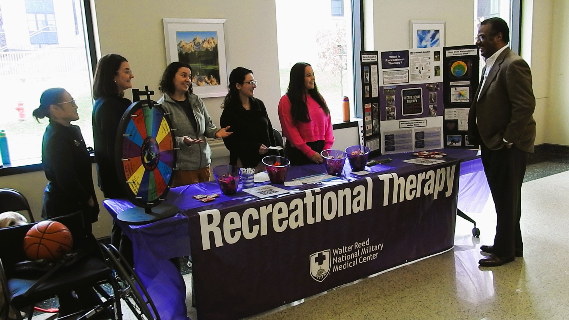 Department of Rehabilitation staff members at Walter Reed, including Recreational Therapists Cara Navarro, Stephanie Seeley, Jennifer Beattie, Jennifer Zumwalde, Meghan Campano, and Jahniya Kiliru-Liontree,  recognized National Recreational Therapy (RT) Month, observed during February, with an information table set up in the America Building at the medical center Feb. 14 for patients, staff and visitors to learn about Recreational Therapy and its benefits.