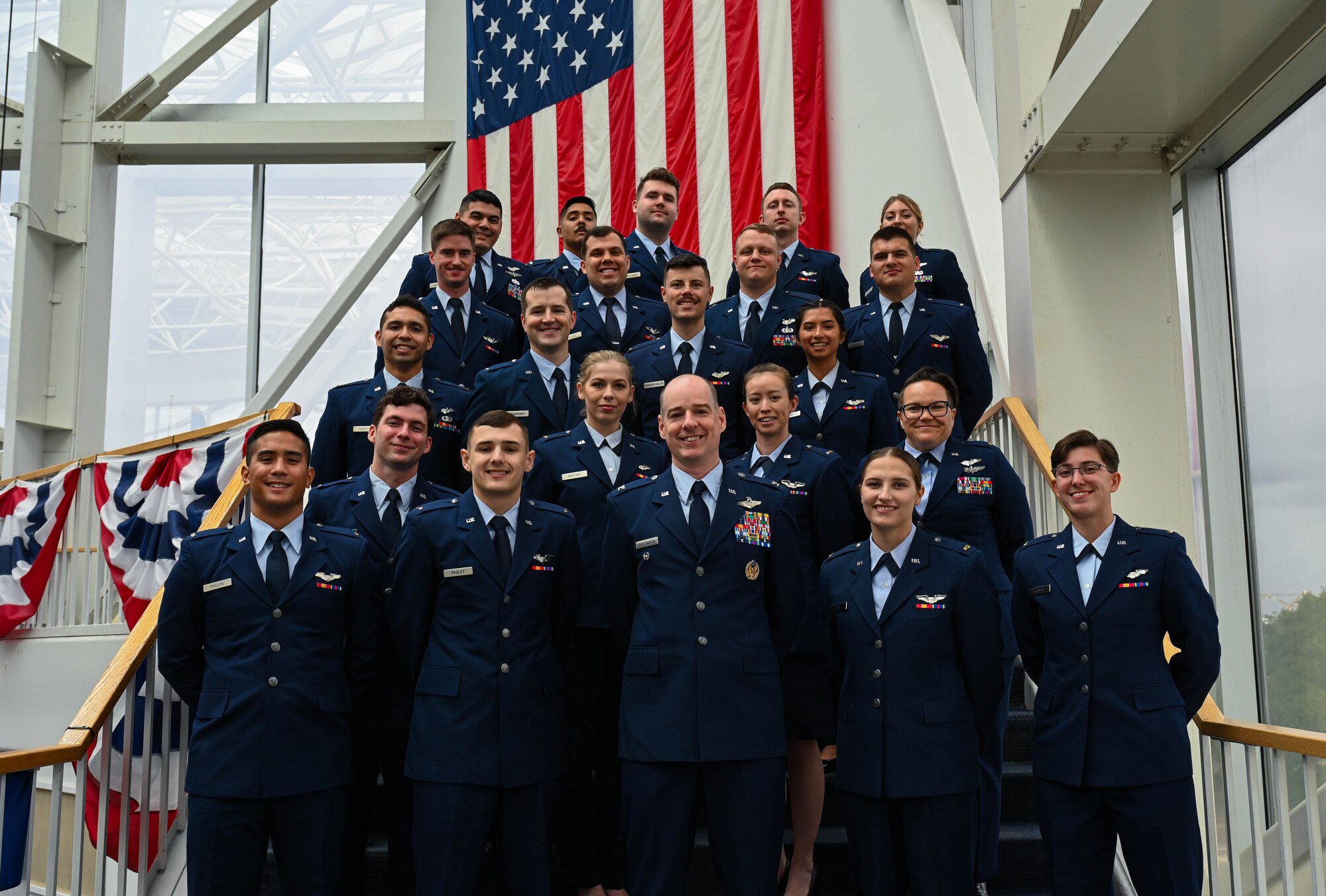 U.S. Air Force Col. John Christianson, 350th Spectrum Warfare Wing deputy commander, center, poses for a group photo with the recent graduates from the Undergraduate Combat Systems Officers Course at the National Naval Aviation Museum, Naval Air Station Pensacola, Fla., Feb. 16, 2024. The 479th Flying Training Group conducts Combat Systems Officer training for newly commissioned U.S. Air Force officers. (U.S. Air Force photo by Capt. Benjamin Aronson)