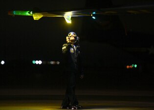 A Sailor from the Blue Angels inspects an aircraft during winter training at NAF El Centro.