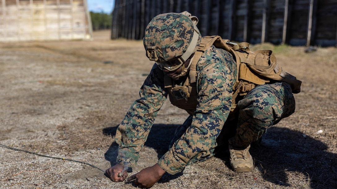 U.S. Marine Corps Lance Cpl. Ronaldo Hodge, a supply chain and materiel management specialist with 8th Engineer Support Battalion, 2nd Marine Logistics Group, pulls a fuse during a basic demolition range on Camp Lejeune, North Carolina, Feb. 13, 2024. The training exposed 2nd MLG and 2nd Marine Division Marines to the EOD program, enhancing their baseline understanding of EOD and generate interest as potential lateral move candidates . (U.S. Marine Corps photo by Cpl. Alfonso Livrieri)