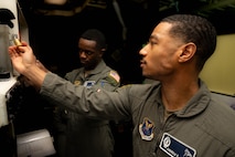 U.S. Air Force Capt. Andrew Gould, flight commander, and 2nd Lt. Ahmad Gage, missileer from the 742nd Missile Squadron, practice together in a missile procedure trainer in recognition of Black History Month at Minot Air Force Base, North Dakota, Feb. 20, 2024. The crew tripped out for a week where they performed a crucial role in the 91st Missile Wings’ nuclear deterrence mission, while also honoring the history and culture of black Americans. (U.S. Air Force photo by Senior Airman Alexander Nottingham)