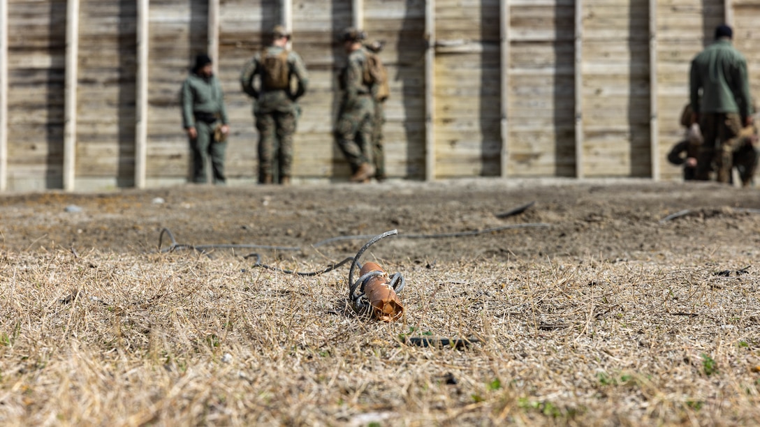 Explosive ordnance disposal technicians with 8th Engineer Support Battalion, Combat Logistics Regiment 27, 2nd Marine Logistics Group, teach Marines with 2nd MLG and 2nd Marine Division, proper procedures to light a stick of dynamite during a demolition range on Camp Lejeune, North Carolina, Feb. 13, 2024. The training exposed 2nd MLG and 2nd Marine Division Marines to the EOD program, enhancing their baseline understanding of EOD and generate interest as potential lateral move candidates . (U.S. Marine Corps photo by Cpl. Alfonso Livrieri)