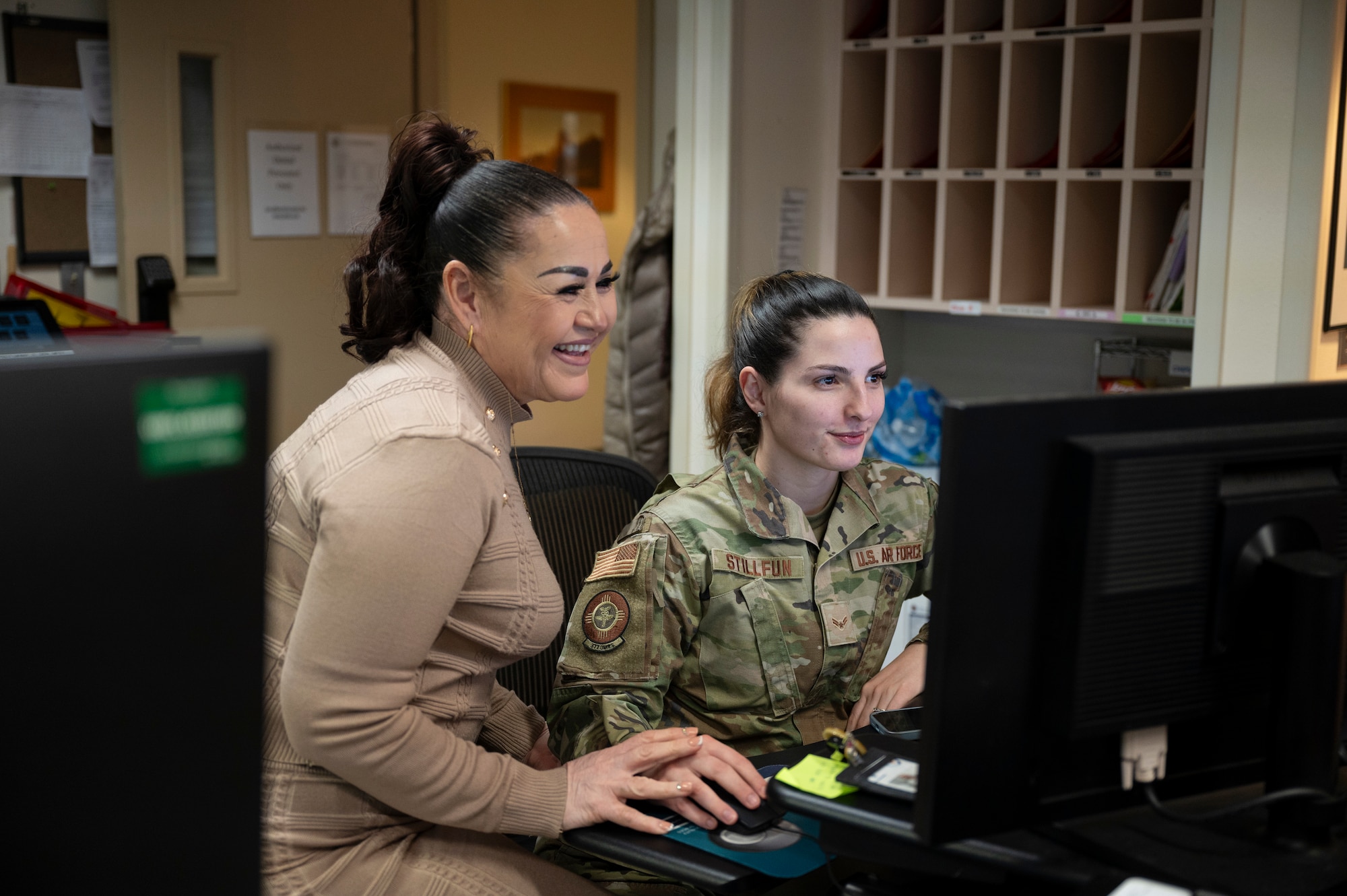 Two women work.