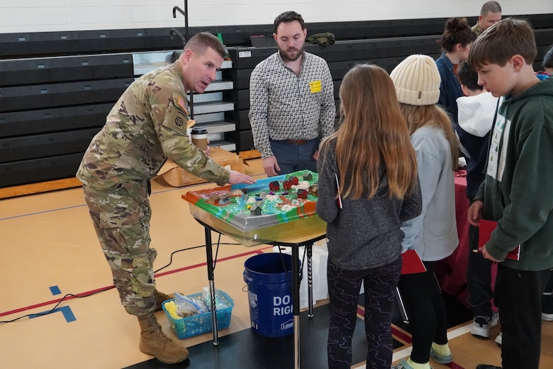 Col. Ronald J. Sturgeon, U.S. Army Corps of Engineers, Savannah District, commander, uses a wetlands model to explain stormwater management to students at McAllister Elementary School during the school’s ninth annual career day, in Richmond Hill, Georgia, Feb. 9, 2024.