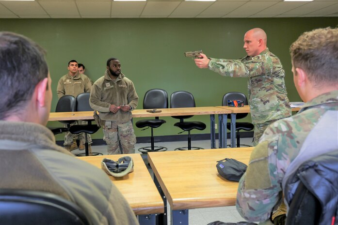 U.S. Air Force Tech. Sgt. Chance Scharer, 9th Logistics Readiness Squadron petroleum, oil, and lubricants (POL) NCO in charge of fuels, environmental and safety (right), learns proper shooting techniques from Senior Airman Johnathan Gibbs, 9th Security Forces Squadron Combat Arms Training and Maintenance (CATM) instructor, during the Tactical Response Team tryouts Feb. 12, 2024, at Beale Air Force Base, California.