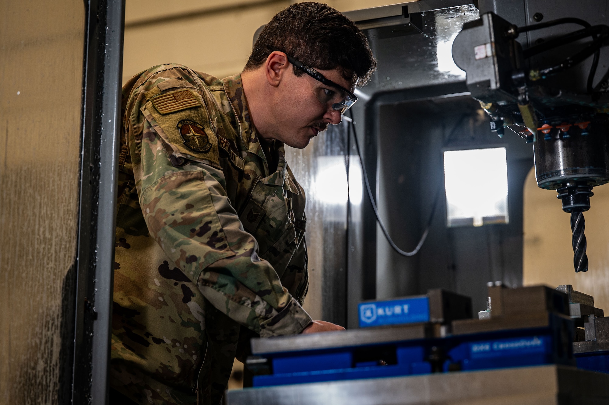 Tech. Sgt. Jordan Barfield, 305th Maintenance Squadron aircraft metals technician, operates a computer numerical control machine to fabricate C-17 Globemaster III components at Joint Base McGuire-Dix-Lakehurst, N.J., Feb 15, 2024. Maintainers from the 305th MXS completed a five-month fabrication project for a damaged C-17, reaffirming Air Mobility Command’s strategic advance and rapid global mobility. (U.S. Air Force photo by 2nd Lt. Alexis Kula)