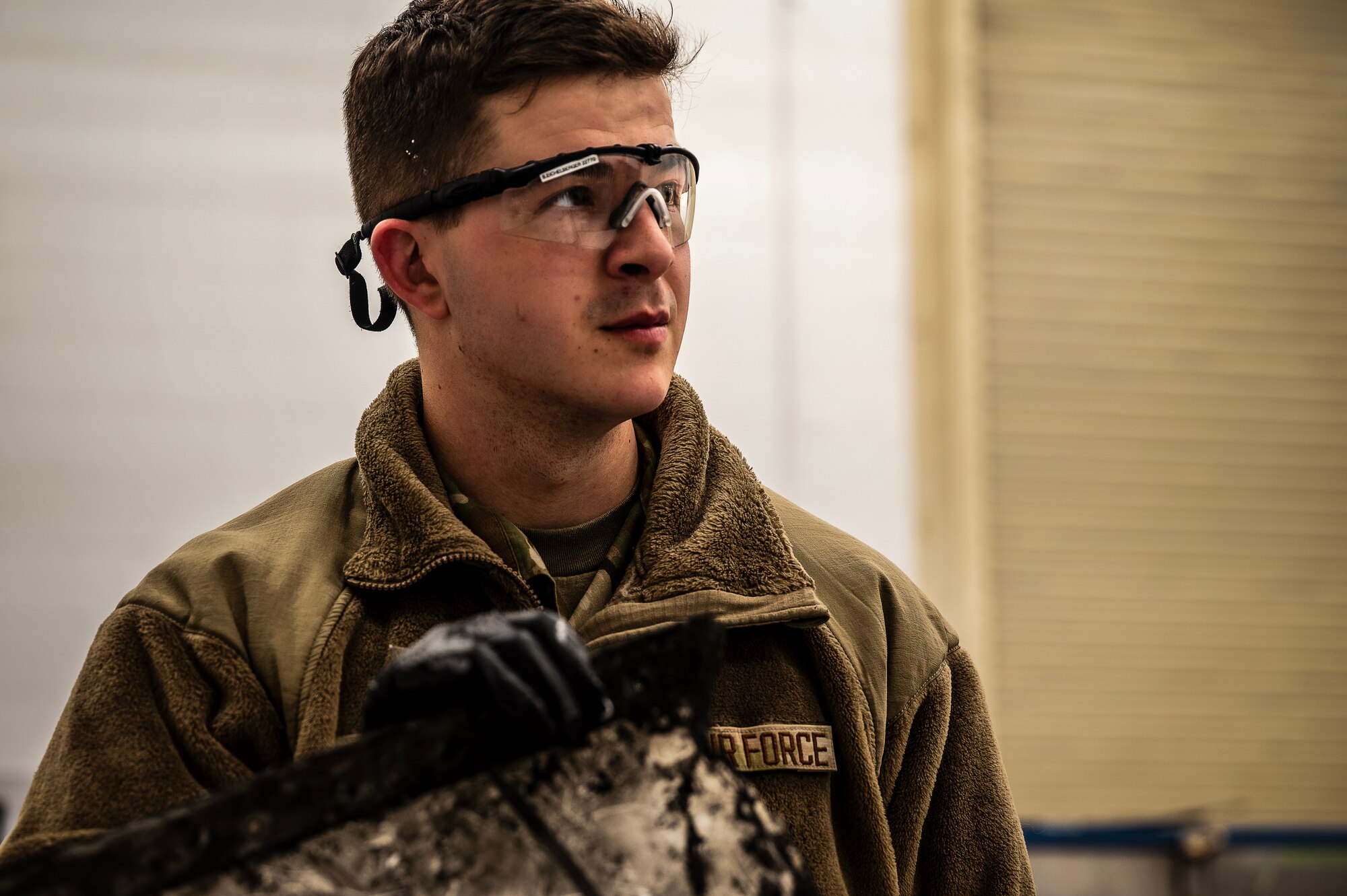 Airman 1st Class Gavin Remp, 305th Maintenance Squadron [DUTY TITLE], assesses damage to a C-17 Globemaster III panel at Joint Base McGuire-Dix-Lakehurst, N.J., Feb 15, 2024. Maintainers from the 305th MXS completed a five-month fabrication project for a damaged C-17, reaffirming Air Mobility Command’s strategic advance and rapid global mobility. (U.S. Air Force photo by 2nd Lt. Alexis Kula)