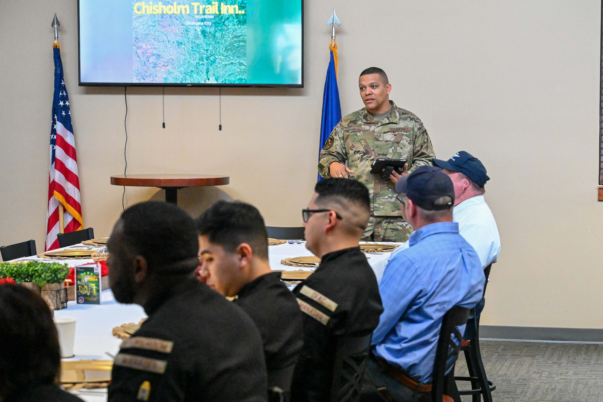 Tech. Sgt. Briton Hurdle, 22nd Force Support Squadron dining facility manager, presents a slideshow for the Hennessy Award critics at McConnell Air Force Base, Kansas, Feb. 15, 2024. The Hennessy Award is an annual recognition given to the base with the best dining facility in the Air Force. (U.S. Air Force photo by Airman 1st Class William Lunn)