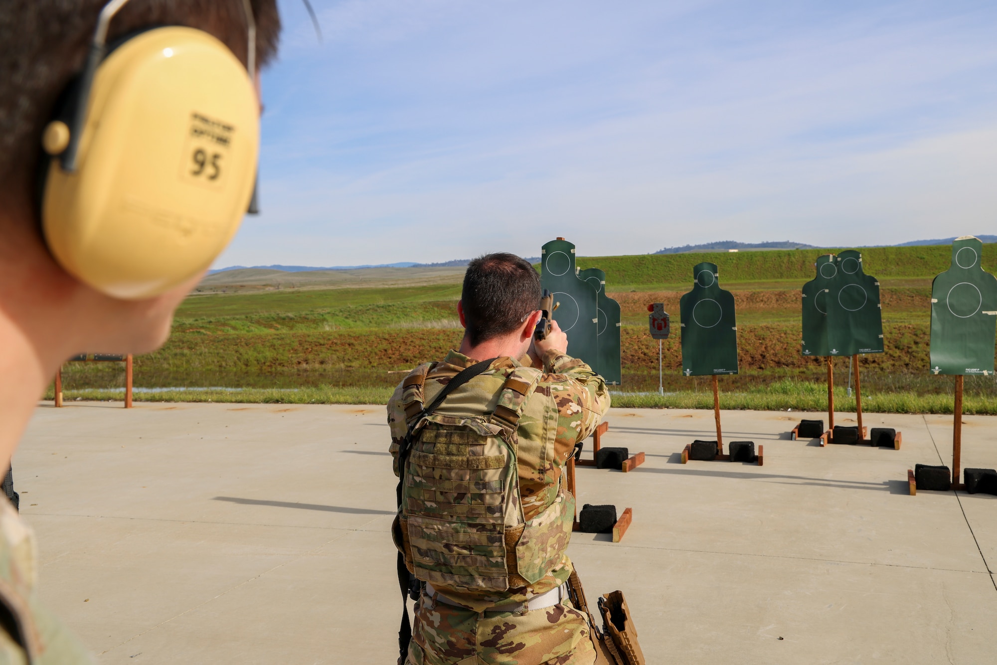 U.S. Air Force Capt. Dustin Fontenot, 427th Reconnaissance Squadron flight safety officer, fires a Sig Sauer M18 during the shooting qualification of the Tactical Response Team (TRT) tryouts Feb. 12, 2024, at Beale Air Force Base, California.