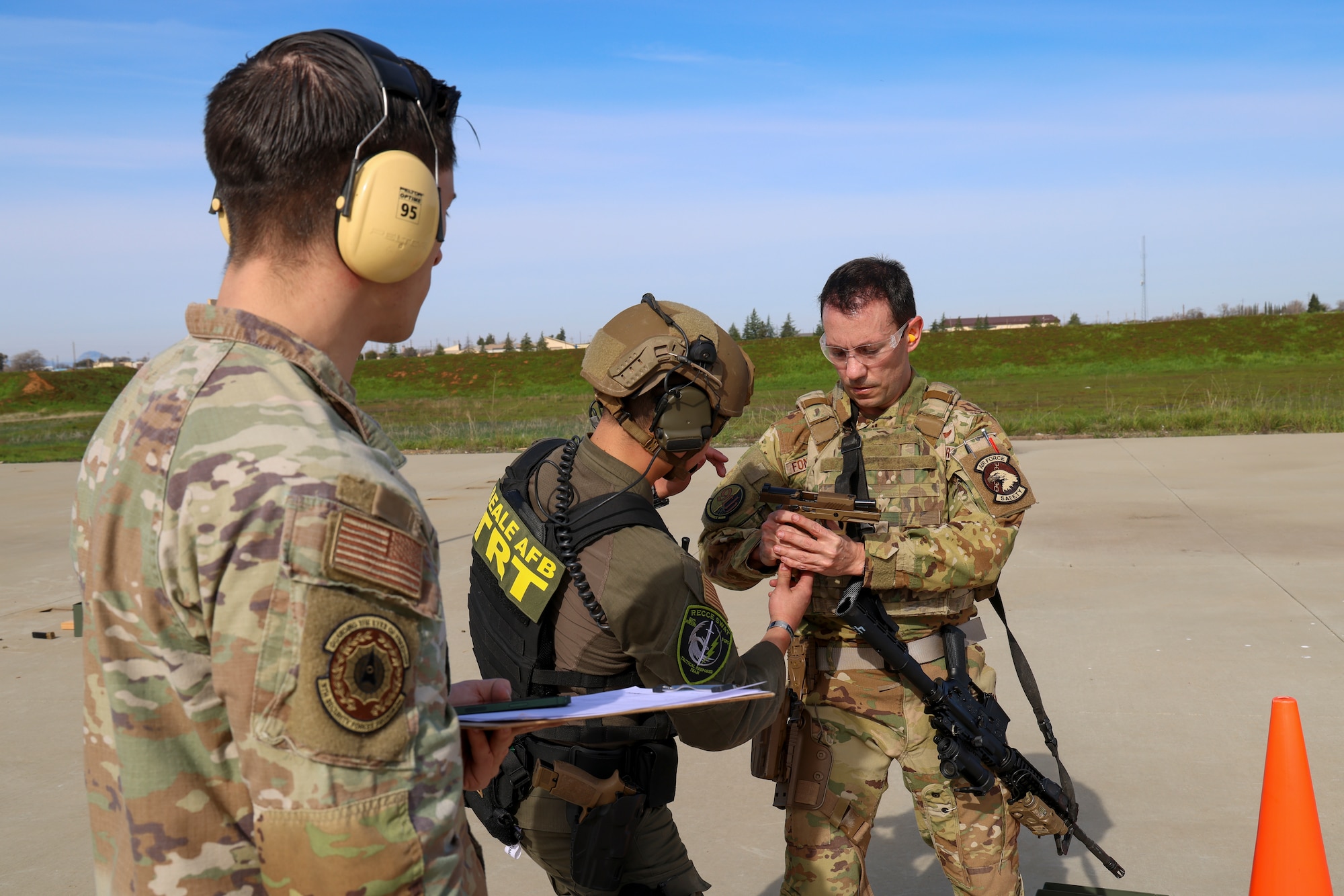 U.S. Air Force Capt. Dustin Fontenot, 427th Reconnaissance Squadron flight safety officer, shows the Combat Arms Training and Maintenance (CATM) instructor his Sig Sauer M18 is safe during the shooting qualification of the Tactical Response Team (TRT) tryouts Feb. 12, 2024, at Beale Air Force Base, California.
