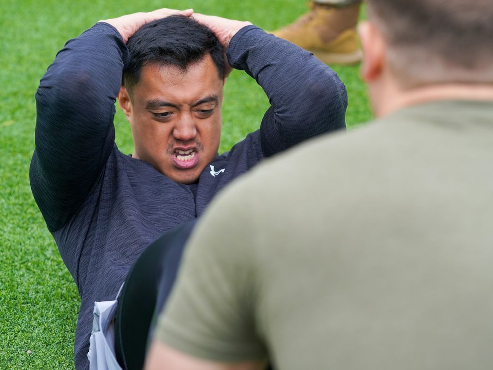 U.S. Air Force Capt. Giovanni Valera, 48th Intelligence Support Squadron cyber operation officer in charge, performs sit-ups during the physical fitness qualification of the Tactical Response Team (TRT) tryouts Jan. 31, 2024, at Beale Air Force Base,