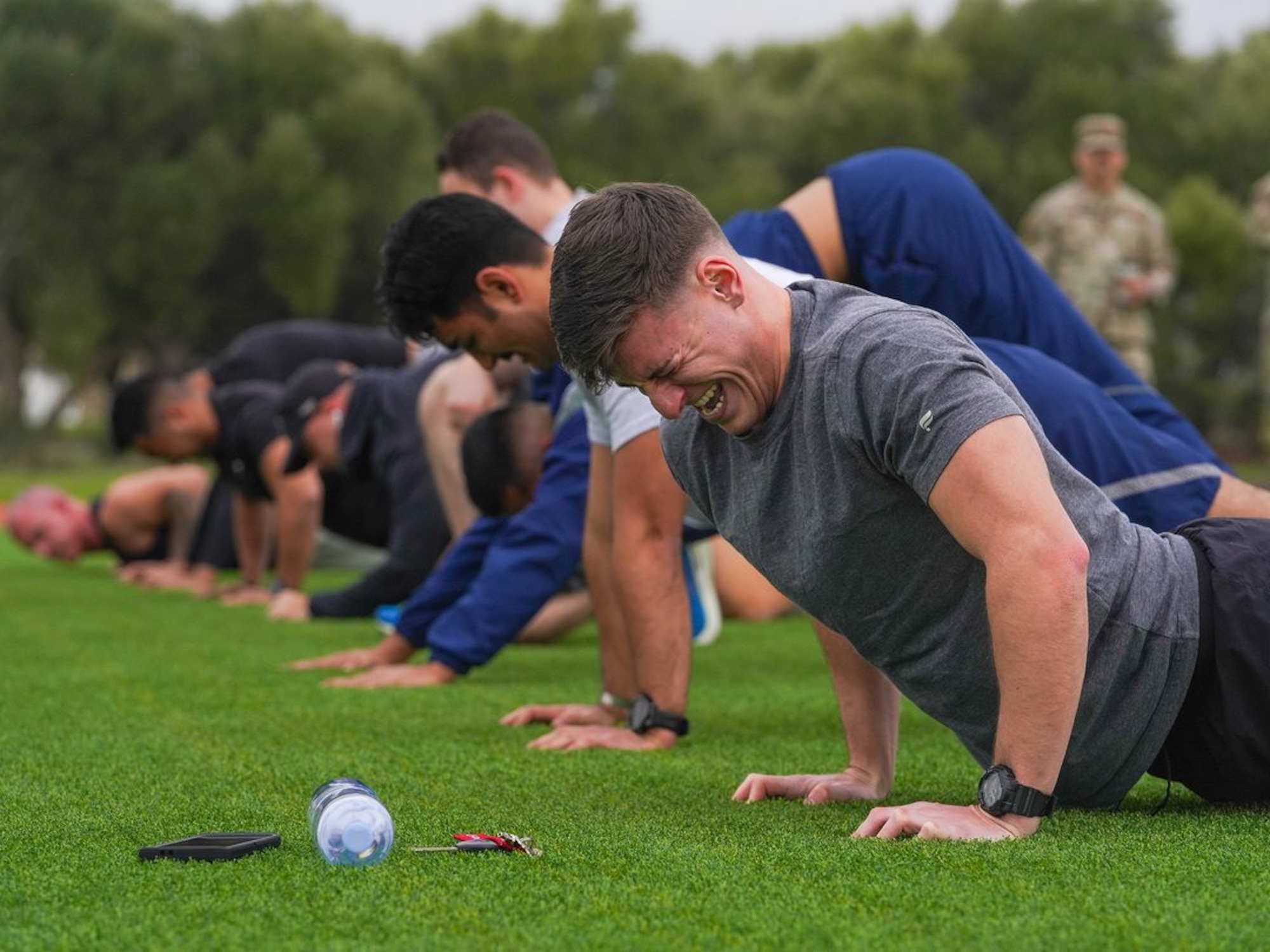 United States Air Force Airmen perform push-ups during the physical fitness qualification of the Tactical Response Team (TRT) tryouts Jan. 31, 2024, at Beale Air Force Base, California.