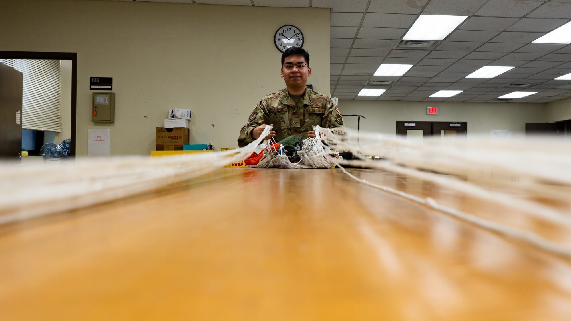 Senior Airman Andrew Rameriz prepares a parachute for inspection at Kunsan Air Base.