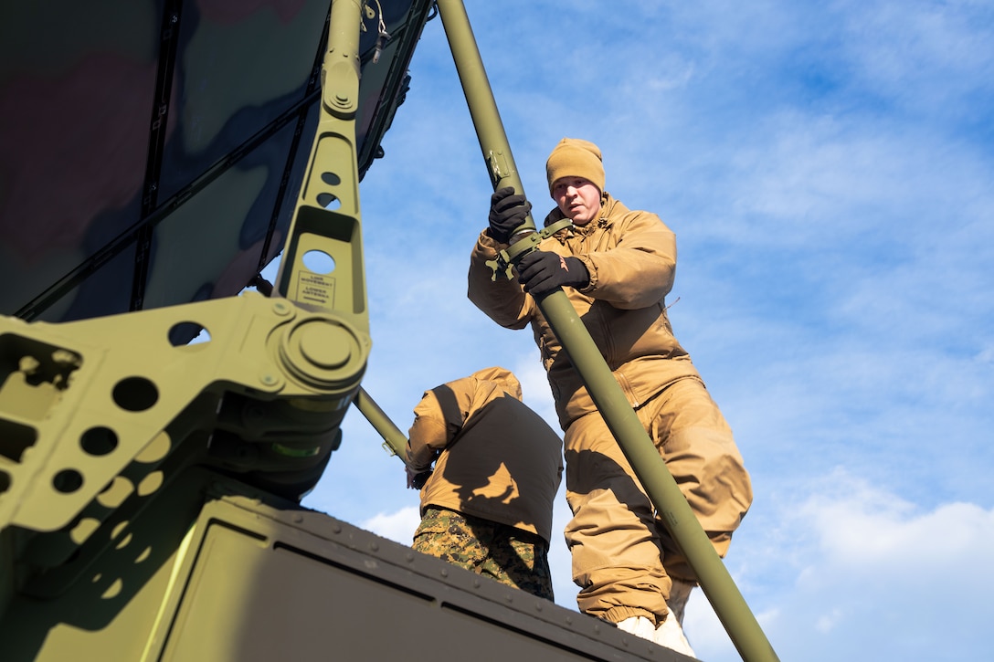 U.S. Marine Corps Lance Cpl. Mathew Colley, a radar technician with Marine Air Control Squadron 24 (MACS-24), Marine Air Control Group 48, 4th Marine Aircraft Wing, Marine Forces Reserve, assembles the stabilizers of an AN/TPS-80 Ground/Air Task Oriented Radar (G/ATOR) in preparation of Exercise ARCTIC EDGE 2024 at Fort Greely, Alaska, Feb. 10, 2024. The G/ATOR is a crucial component of the Marine Air Command and Control System, supporting the Air Combat Element (ACE) of the Marine Air-Ground Task Force (MAGTF). ARCTIC EDGE 2024 (AE24) is a U.S. Northern Command-led homeland defense exercise demonstrating the U.S. military’s capabilities in extreme cold weather, joint force readiness, and U.S. military commitment to mutual strategic security interests in the arctic region. (U.S. Marine Corps photo by Lance Cpl. Madisyn Paschal)
