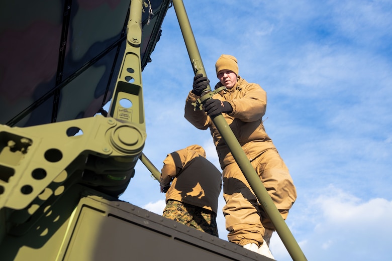 U.S. Marine Corps Lance Cpl. Mathew Colley, a radar technician with Marine Air Control Squadron 24 (MACS-24), Marine Air Control Group 48, 4th Marine Aircraft Wing, Marine Forces Reserve, assembles the stabilizers of an AN/TPS-80 Ground/Air Task Oriented Radar (G/ATOR) in preparation of Exercise ARCTIC EDGE 2024 at Fort Greely, Alaska, Feb. 10, 2024. The G/ATOR is a crucial component of the Marine Air Command and Control System, supporting the Air Combat Element (ACE) of the Marine Air-Ground Task Force (MAGTF). ARCTIC EDGE 2024 (AE24) is a U.S. Northern Command-led homeland defense exercise demonstrating the U.S. military’s capabilities in extreme cold weather, joint force readiness, and U.S. military commitment to mutual strategic security interests in the arctic region. (U.S. Marine Corps photo by Lance Cpl. Madisyn Paschal)