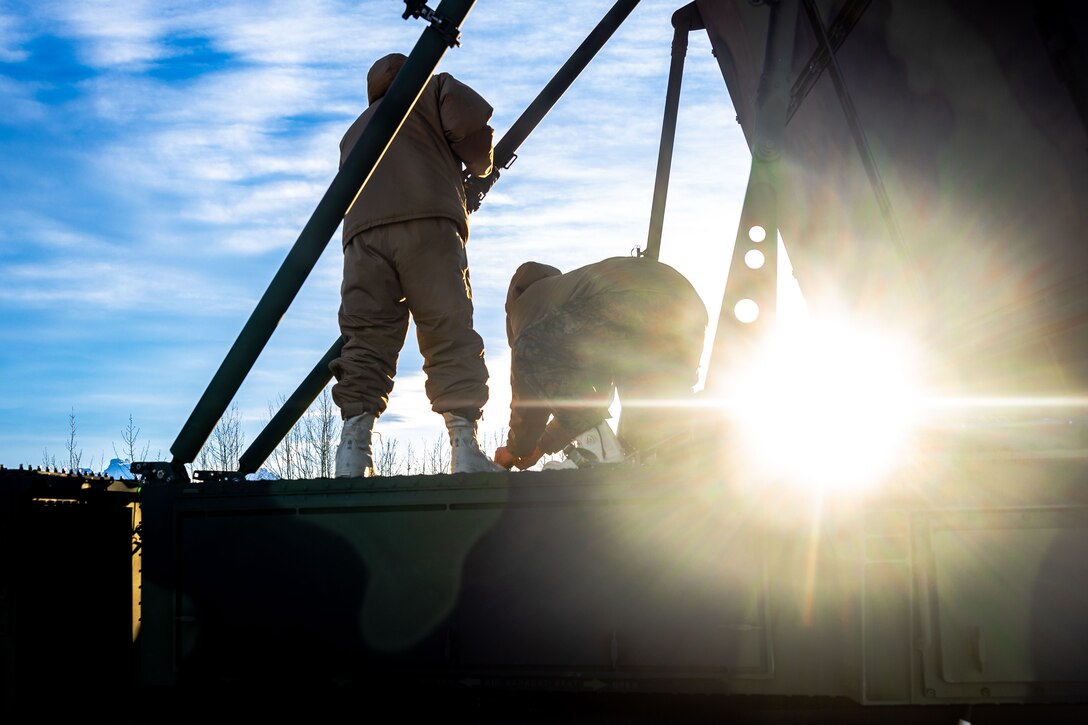 U.S. Marine Corps Lance Cpl. Mathew Colley (left) and Cpl. Toby Callaway (right), radar technicians with Marine Air Control Squadron 24 (MACS-24), Marine Air Control Squadron 48, 4th Marine Aircraft Wing, Marine Forces Reserve, finish setting up an AN/TPS-80 Ground/Air Task Oriented Radar (G/ATOR) in preparation of Exercise ARCTIC EDGE 2024 at Fort Greely, Alaska, Feb. 10, 2024. The G/ATOR offers real-time information on-air threats, enabling air control squadrons to effectively manage airspace and ensure the safety and efficiency of joint air operations in any environment, including harsh arctic conditions. ARCTIC EDGE 2024 (AE24) is a U.S. Northern Command-led homeland defense exercise demonstrating the U.S. military’s capabilities in extreme cold weather, joint force readiness, and U.S. military commitment to mutual strategic security interests in the arctic region. (U.S. Marine Corps photo by Lance Cpl. Madisyn Paschal)