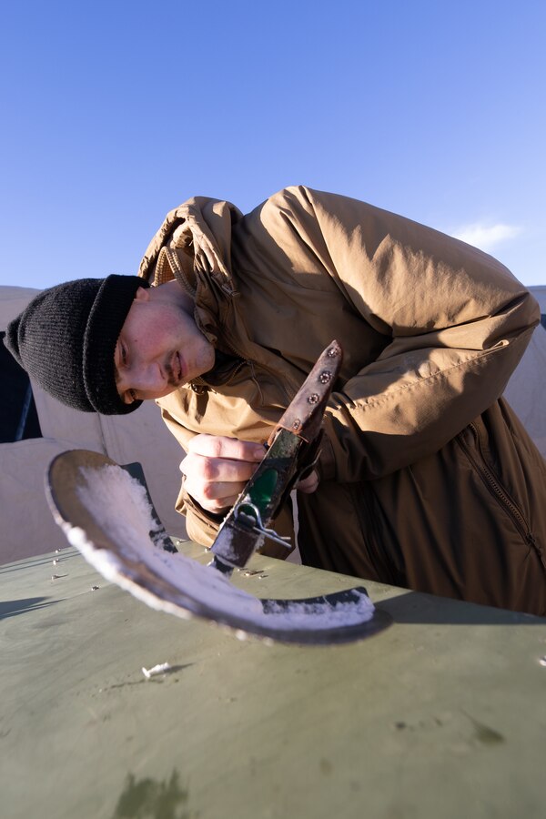 U.S. Marine Corps Lance Cpl. Joshua Schroeder, an aviation communications systems technician with Marine Air Control Squadron (MACS) 24, Marine Air Control Group 48, 4th Marine Aircraft Wing, Marine Forces Reserve, prepares an entrenching tool to clear excess snow at Fort Greely, Alaska, Feb. 10, 2024, in preparation for exercise ARCTIC EDGE 2024 (AE24). AE24 is a U.S. Northern Command-led homeland defense exercise demonstrating the U.S. Military's capabilities in extreme cold weather, joint force readiness, and U.S. military commitment to mutual strategic security interests in the Arctic region. Schroeder drills out of Virginia Beach, Va. (U.S. Marine Corps photo by Staff Sgt. Jestin Costa)