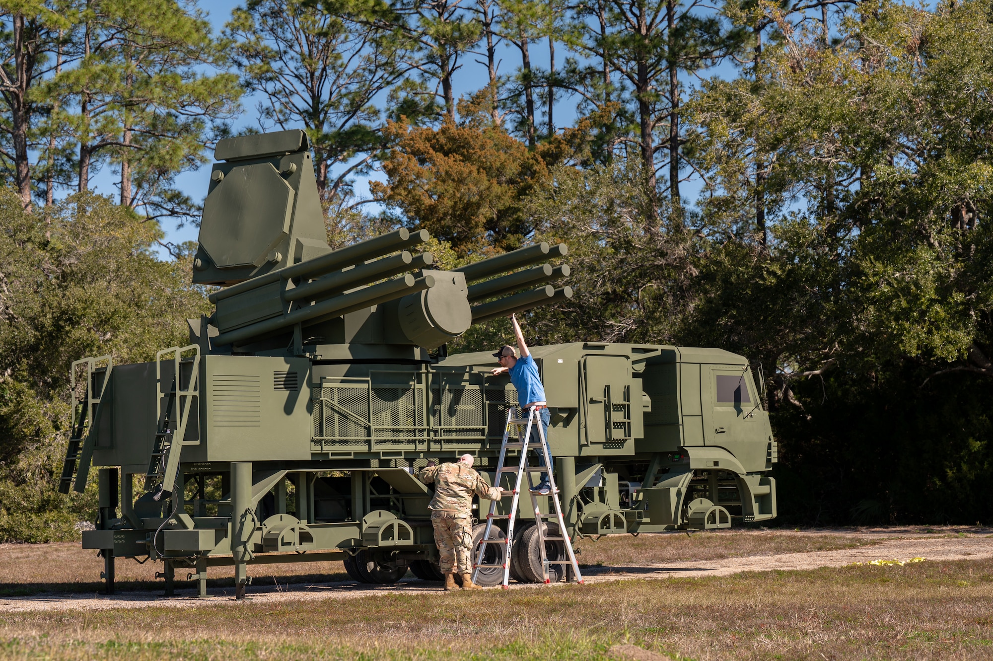 Two people set up a piece of equipment