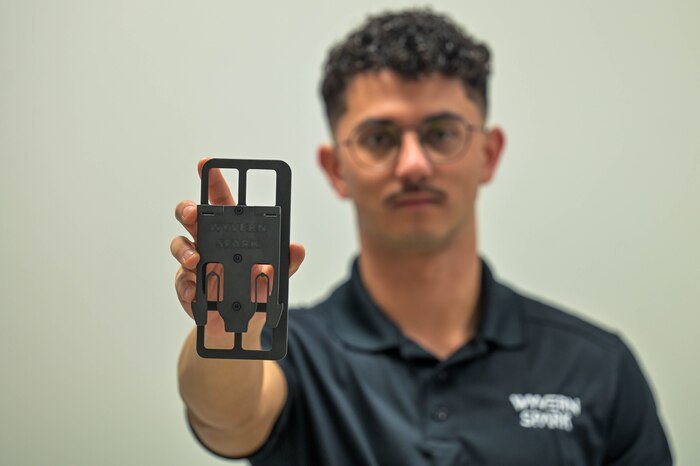 An Airman showcases a 3D printed model.