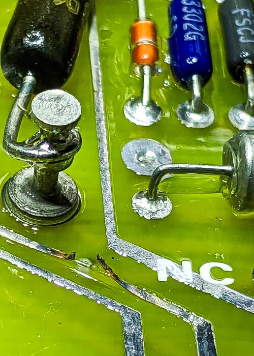 A broken trace sits on a circuit board.