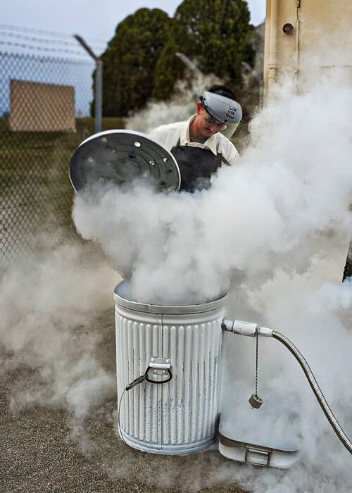 Airman drains liquid oxygen cart.