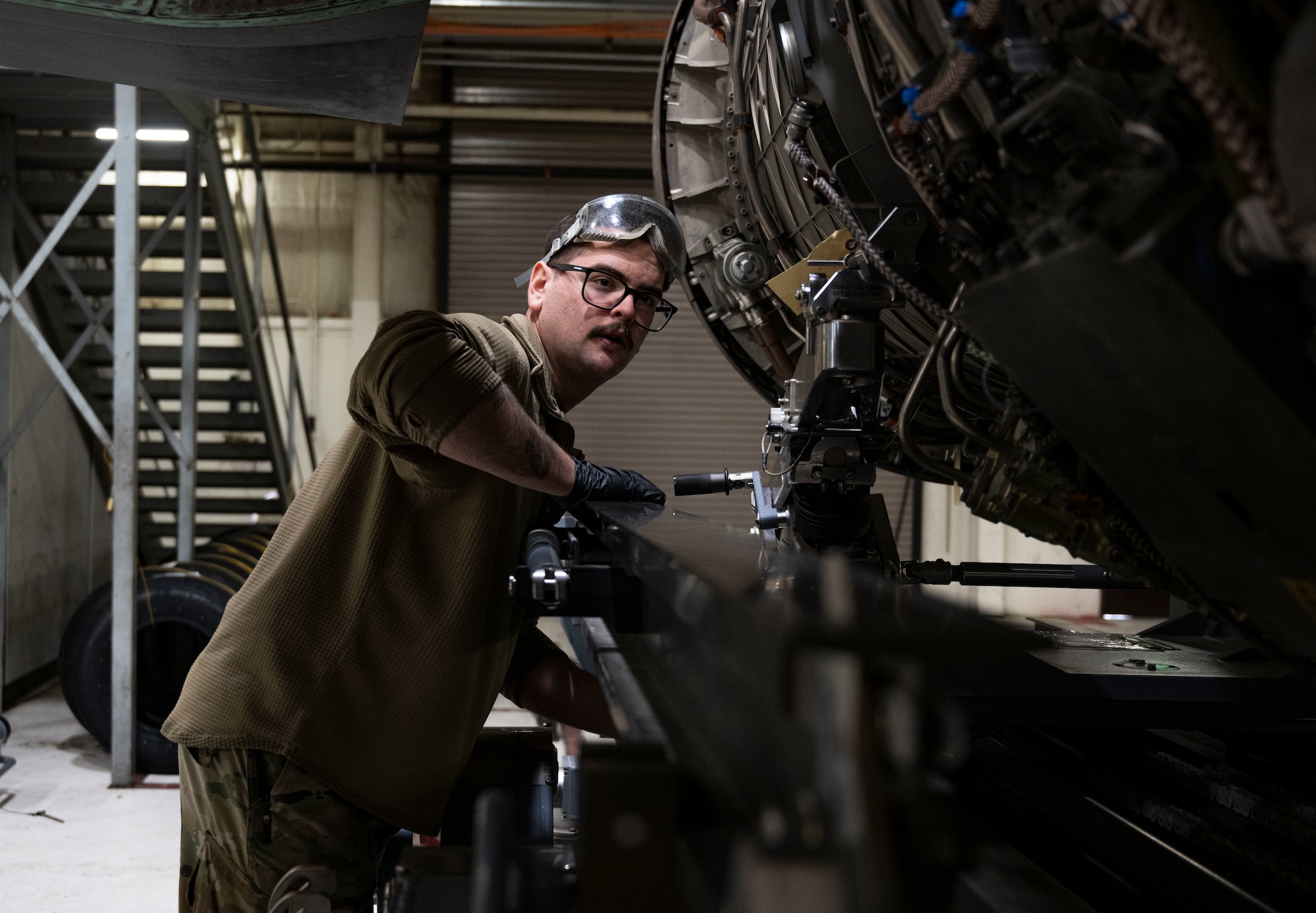 A photo of maintainers installing an engine into an F-35A Lightning II fighter jet.