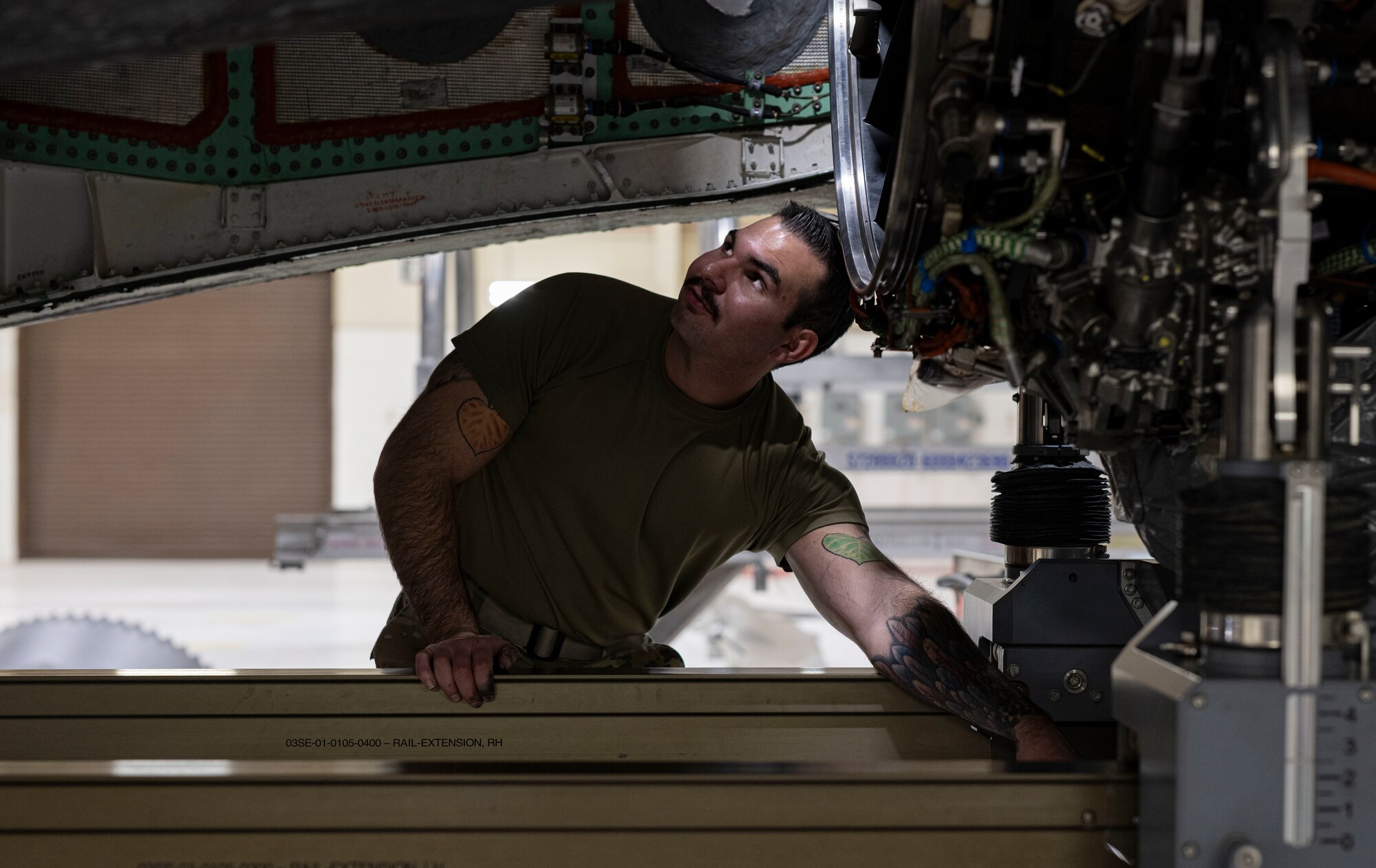 A photo of maintainers installing an engine into an F-35A Lightning II fighter jet.