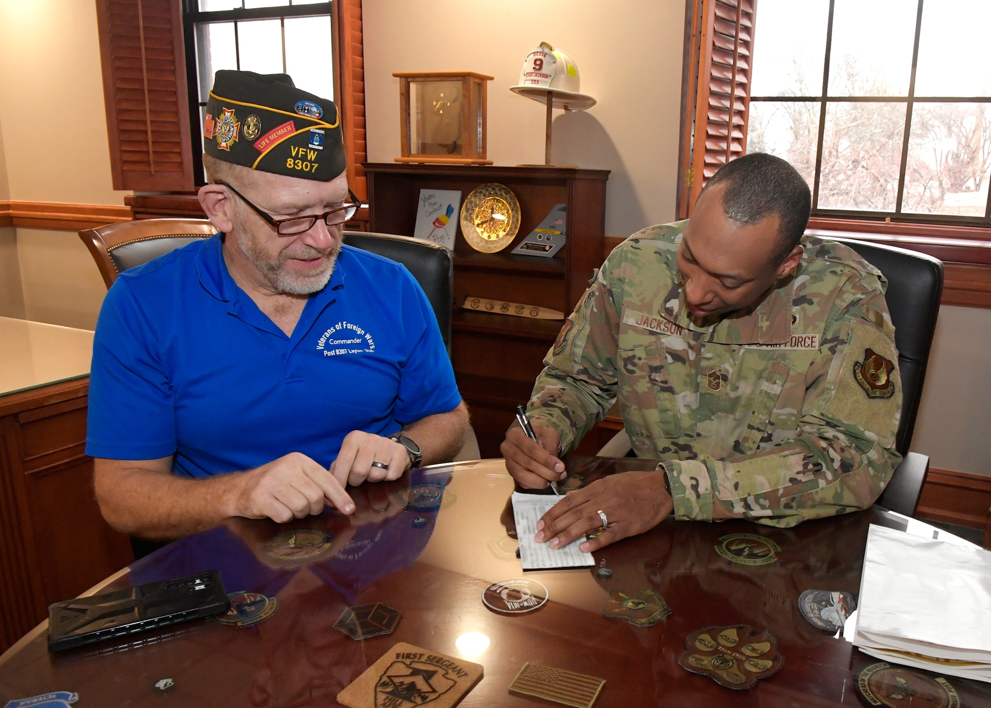 (Left to right) Rich Ludwich, Veterans of Foreign Wars Post 8307 commander, registers Chief Master Sgt. Vernon Jackson, 75th Air Base Wing command chief, with the VFW, Feb. 21 at Hill Air Force Base, Utah. The VFW, a veteran’s support organization, is partnering with the base and has adopted Operation Warm Heart, a private organization that supports the installation's Airmen, Guardians and their families. (U.S. Air Force photo by Todd Cromar)
