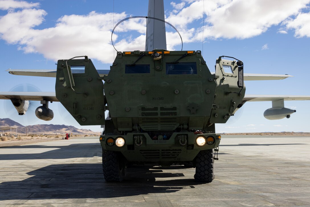 A U.S. Marine Corps M142 High Mobility Artillery Rocket System assigned to 1st Battalion, 11th Marines, 1st Marine Division, commences a HIMARS Rapid Infiltration after being deployed from a KC-130J Hercules during Integrated Training Exercise 2-24, at the Strategic Expeditionary Landing Field, Marine Corps Air-Ground Combat Center Twentynine Palms, California, Feb. 10, 2024. The HIRAIN exercise demonstrated I Marine Expeditionary Force’s ability to rapidly deploy the HIMARS to meet and deter any threats. ITX ensures units are ready to “fight tonight” as a I MEF Marine Air-Ground task force. (U.S. Marine Corps photo by Lance Cpl. Jackson Rush)