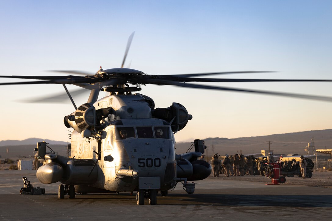 A U.S. Marine Corps CH-53E Super Stallion helicopter assigned to Marine Heavy Helicopter Squadron (HMH) 465, Marine Aircraft Group 16, 3rd Marine Aircraft Wing, prepares to load an Ultra-Light Tactical Vehicle and a fireteam with 1st Marine Reconnaissance Battalion, 1st Marine Division, during Marine Air-Ground Task Force Distributed Exercise (MDMX) at the Marine Corps Air-Ground Combat Center, Twentynine Palms California, Feb. 10, 2024. The Marines with 1st Recon began MDMX by conducting a tactical night insertion into an austere environment. MDMX is a maneuver exercise that incorporates ground, air, and logistics operations over several days. (U.S. Marine Corps photo by Lance Cpl. Jackson Rush)