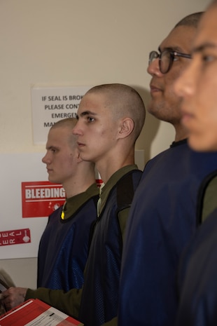 U.S. Marine Corps recruits with Kilo Company, 3rd Recruit Training Battalion, stand by for a medical examination as part of the receiving process at Marine Corps Recruit Depot San Diego, California, Feb. 13, 2024. During receiving week recruits go through administrative and medical processing to ensure training and operational readiness. (U.S. Marine Corps photo by Lance Cpl. Janell B. Alvarez)