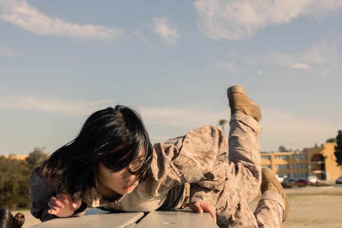 U.S. Marine Corps Recruit Ai Suzuki with Golf Company, 2nd Recruit Training Battalion, climbs over a wall during an obstacle course training event at Marine Corps Recruit Depot San Diego, California, Feb. 15, 2024. The O-Course includes obstacles recruits must overcome to enhance strength, agility, enhance, and confidence. (U.S. Marine Corps photo by Lance Cpl. Janell B. Alvarez)