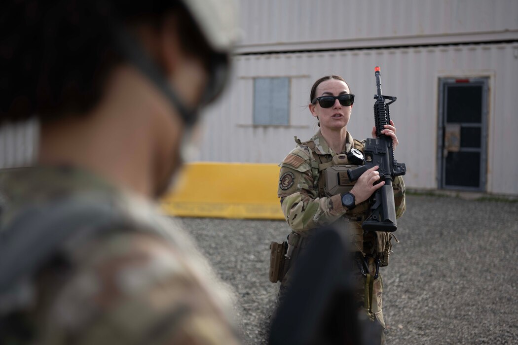 An Airman holds a weapon.