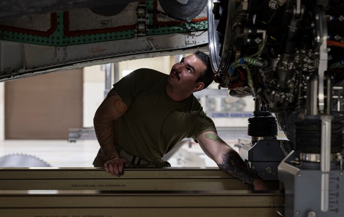 A photo of maintainers installing an engine into an F-35A Lightning II fighter jet.
