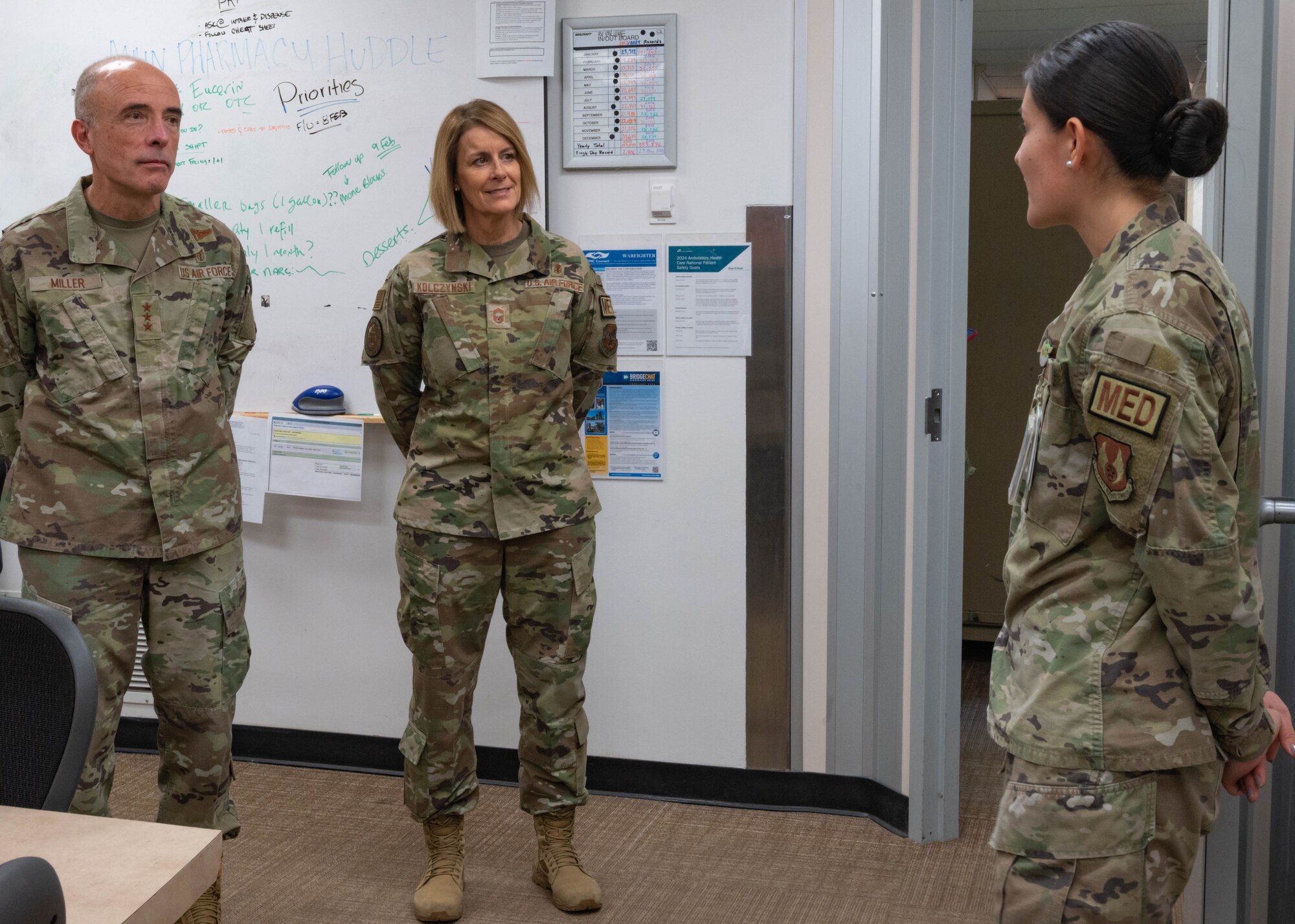 Lt. Gen. Miller and Chief Master Sgt. Dawn Kolcynski stand while being briefed by Staff Sgt. Baca.