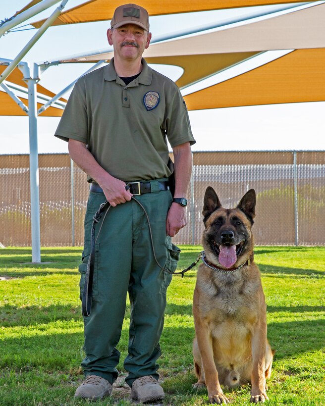 Lieutenant Christopher Dixon, kennel master at the Adam Leigh Cann Canine Facility aboard Marine Corps Logistics Base Barstow, takes a pause in his day at the base kennels in Barstow, California, June 28. Dixon enjoys working with the dogs and appreciates each canine's individual personality at the kennels.