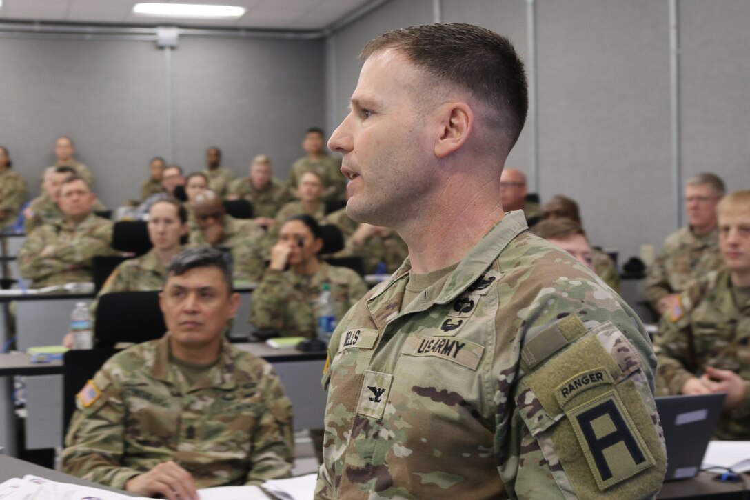 An officer briefs staff