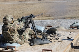 A Soldier fires a machine gun during training