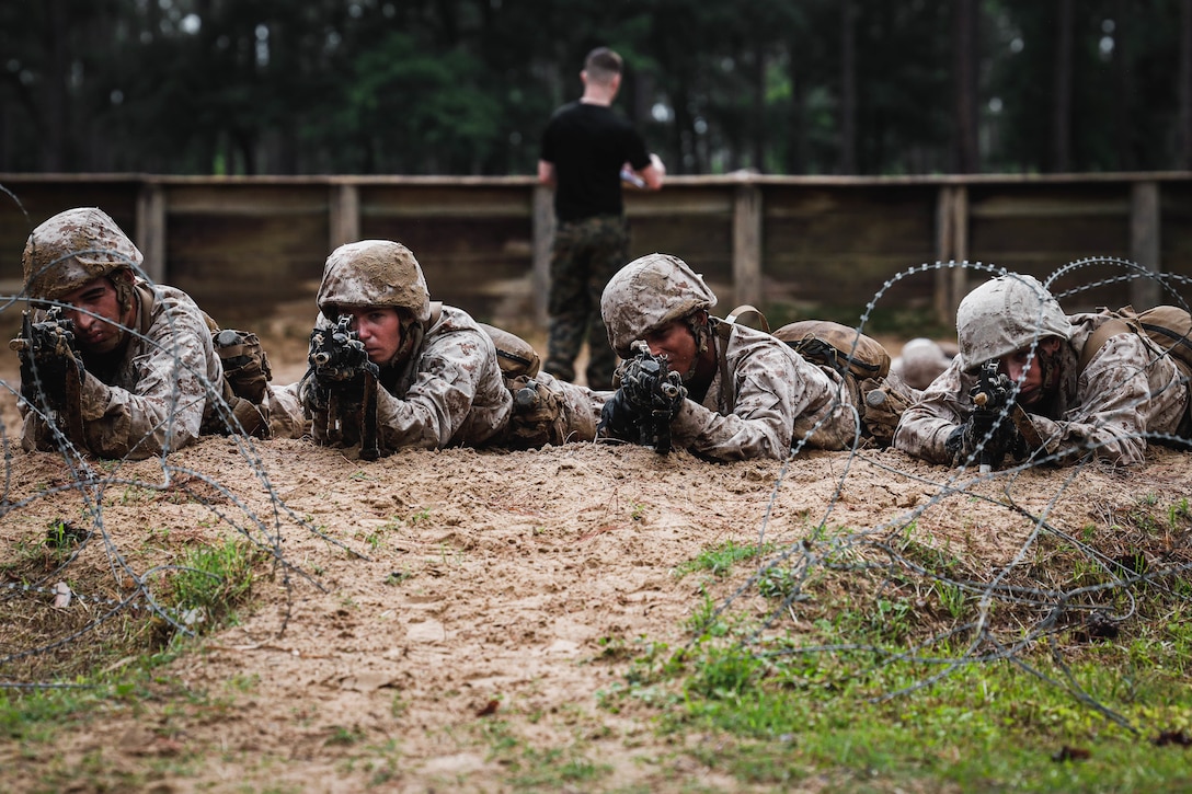 Recruits with India Company, 3rd Recruit Training Battalion, conduct the Day Movement Course on Marine Corps Recruit Depot Parris Island, S.C., May 18, 2023. Recruits conduct the Day Movement Course as part of the Basic Warrior Training Week in order to further their combat conditioning with various maneuvers through the course. (U.S. Marine Corps photo by Lance Cpl. William Horsley)