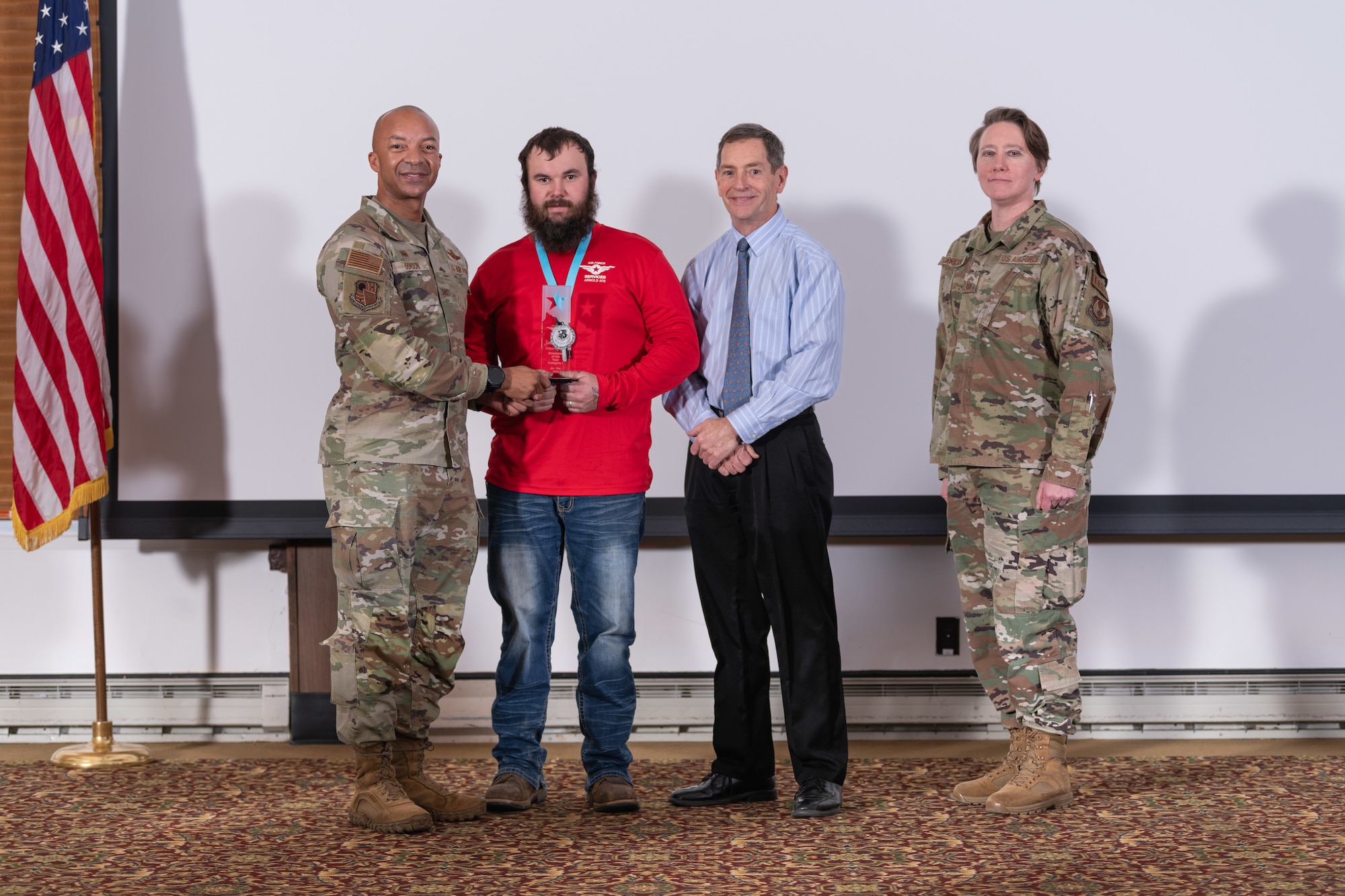 James Ashley with Arnold Air Force Base Services, second from left, accepts the award for Non-appropriated Fund Category I Civilian of the Year during the Arnold Engineering Development Complex Annual Awards ceremony Feb. 15, 2024, at Arnold AFB, Tenn. Also pictured are AEDC Commander Col. Randel Gordon, left, AEDC Deputy Director Kevin Muckerheide and AEDC Senior Enlisted Leader Chief Master Sgt. Jennifer Cirricione. (U.S. Air Force photo by Keith Thornburgh)